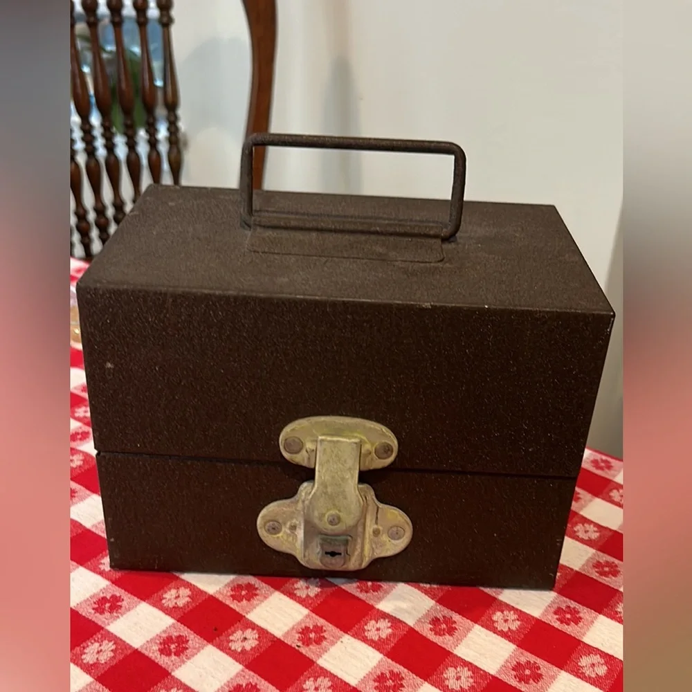 Vintage tin movie reel container with lock